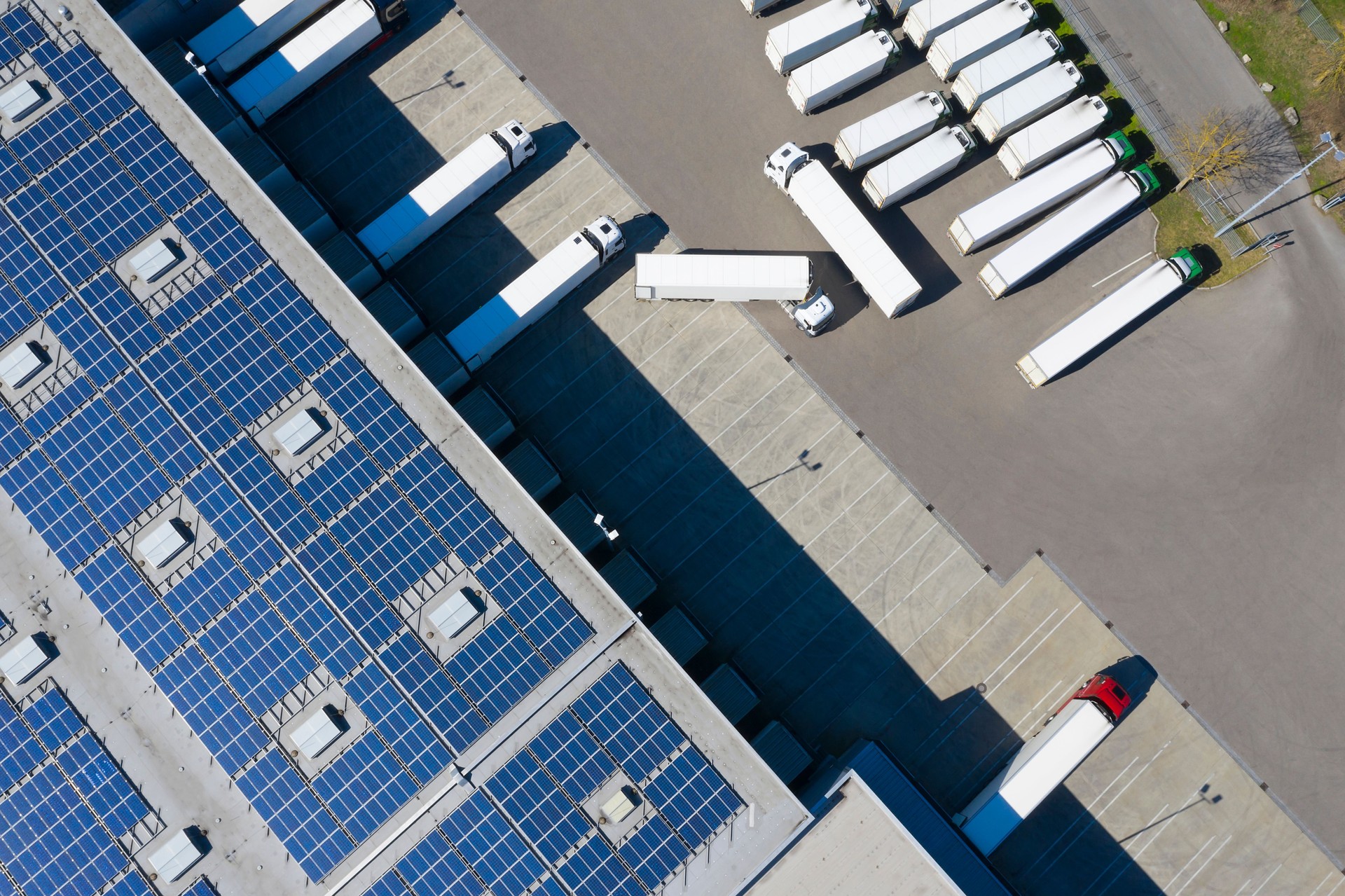 Aerial View of Cargo Containers and Distribution Warehouse with Renewable Energy Plants